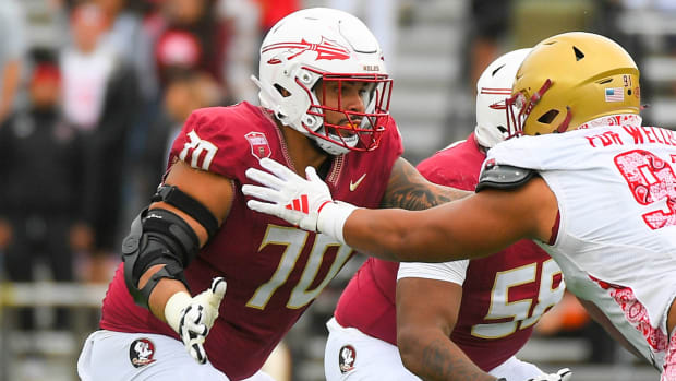 Florida State lineman Casey Roddick blocks a Boston player at the line of scrimmage.